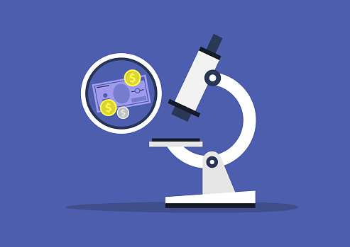 Money devaluation, economic crisis, global recession, paper currency and coins under the microscope glass