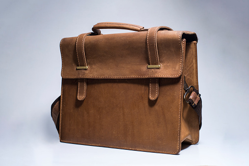 Old brown leather suitcase on white background. Bag for put the camera and other.