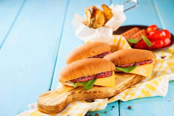 istock breakfast - sandwiches, sausages and tomatoes on a table, selective focus, copy space 1217290272