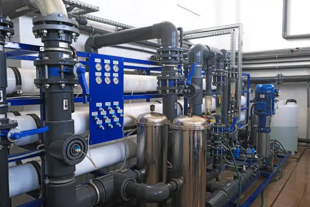 Photo of inside of wastewater treatment facility with water pipes and many manometer indicators, sensors, sampler and rotameters