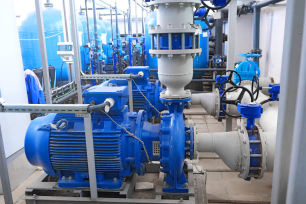 high-pressure pumps engines and pipes, water or wastewater treatment facilities inside or indoors, industrial interior water or wastewater treatment facilities inside or indoors, blue high-pressure pumps engines and gray pipes, industrial interior water pump stock pictures, royalty-free photos & images