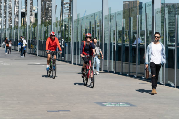 Melbourne Australia - March 10 2019; Cyclists and walkers crossing Sandridge pedestrian bridge