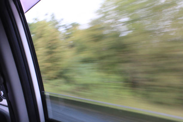 istock fast moving car with the view on window 1217292192
