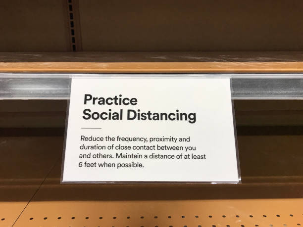 istock Practice Social Distancing sign on the empty shelves in store 1217296842
