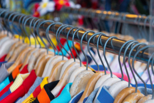 istock Multi-colored t-shirts on a hanger. Clothing store 1217297484