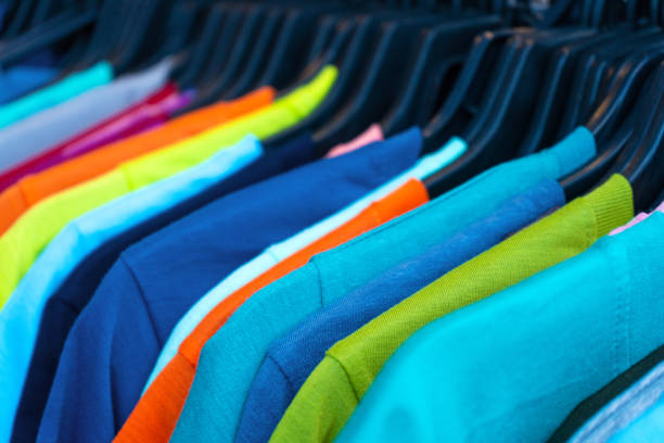 istock Multi-colored t-shirts on a hanger. Clothing store 1217297570