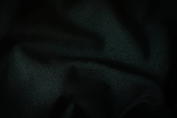 istock Black fabric, luxury dark gray background abstract. Material are used in textile assembly. Detail cloth texture of pattern. Design, elegance with vignette effect, free copy space for text placement. 1217297723