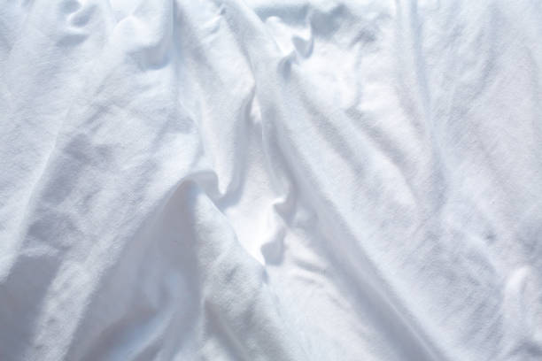 istock White bedsheet drying in the sun, Wrinkled texture, Abstract background, Close up shot, Selective focus, Housework, Laundry concept 1217299761