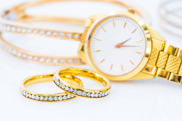 istock Luxury gold ring and lady gold watch on white 1217303366