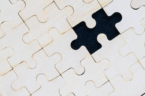 istock Close up wooden jigsaw puzzle pieces on black background 1217303401