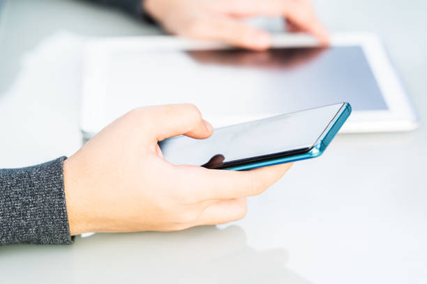 istock Women hands holding phone with screen above 1217303411