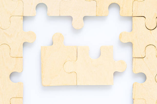 istock wooden jigsaw puzzle pieces on white background 1217303448