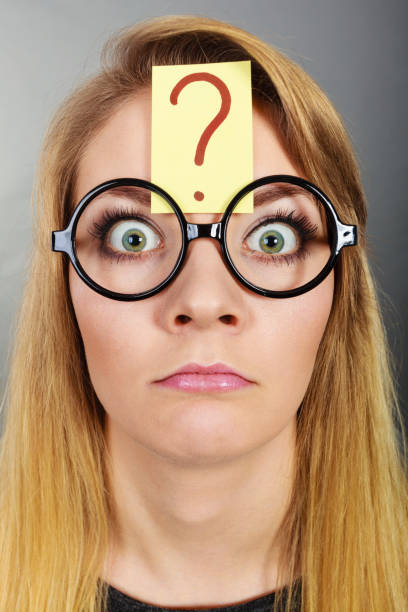 istock Weirdo nerd woman having question mark on forehead 1217303515
