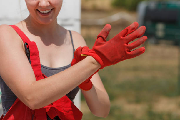 istock Woman putting safety worker gloves 1217303585