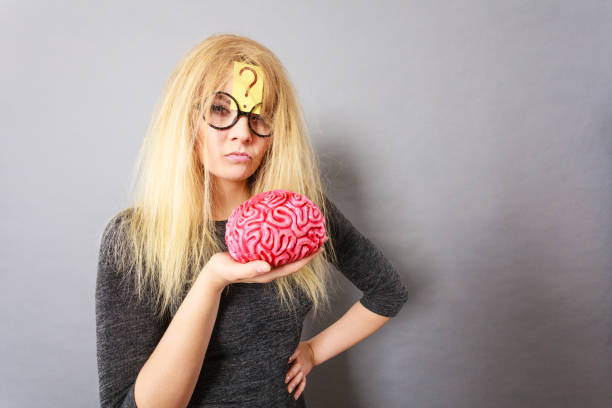 istock Woman holding brain having idea 1217304315