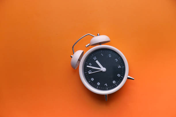 istock close up of alarm clock on colorful background 1217304563