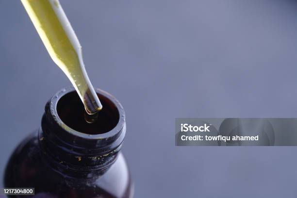 Dispensing Drops Of Healthy Herbal Medicinal Oil Stock Photo - Download Image Now - Cannabis Plant, Removing, Alternative Lifestyle