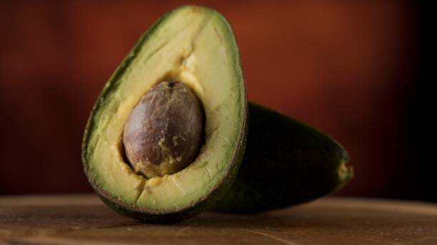 istock Ripe avocado fruit on a wooden surface 1217305657
