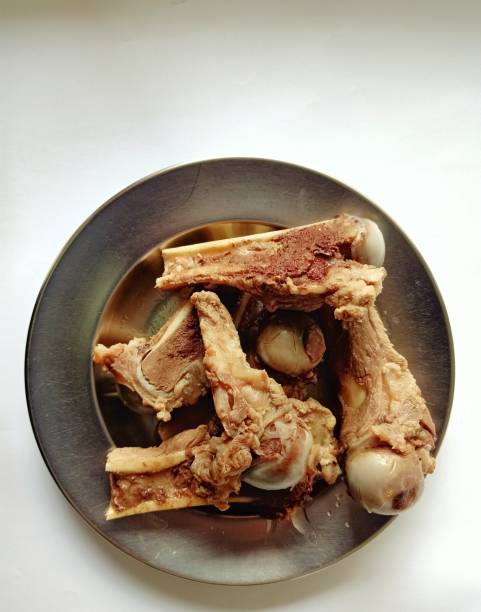 istock Several pieces of pork bone on a plate on a white background 1217306772