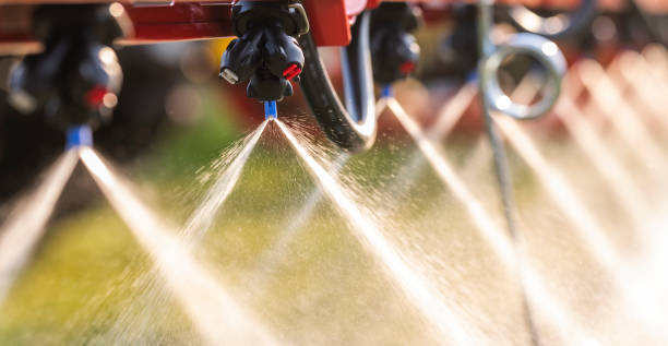 Nozzle of the tractor sprinklers sprayed. Nozzle of the tractor sprinklers sprayed. apply fertilizer stock pictures, royalty-free photos & images