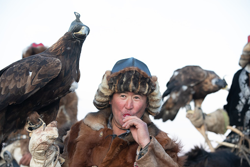 Even the thoughest Kazakh eagle hunters cannot resist a lollipop. Ulgii, Mongolia.