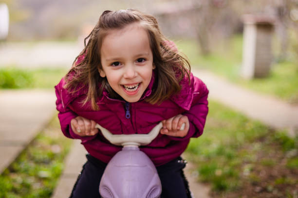 Girl riding a bike in the yard