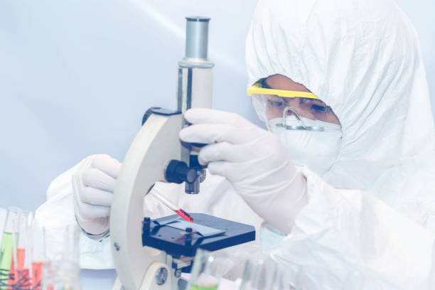 istock Health care researchers working in life science laboratory and analyzing microscope slides in research lab. 1217309471