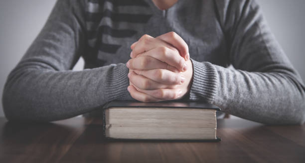 istock Human praying with Bible. Religion concept 1217311549