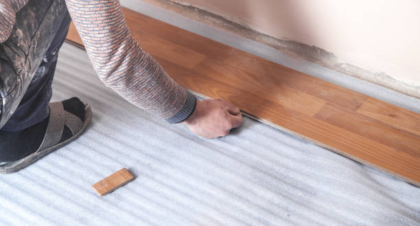 istock Worker installing wood laminate on the floor. 1217311553