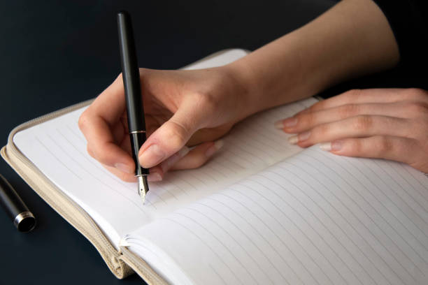 istock Journal writing with fountain pen, dark background 1217313831