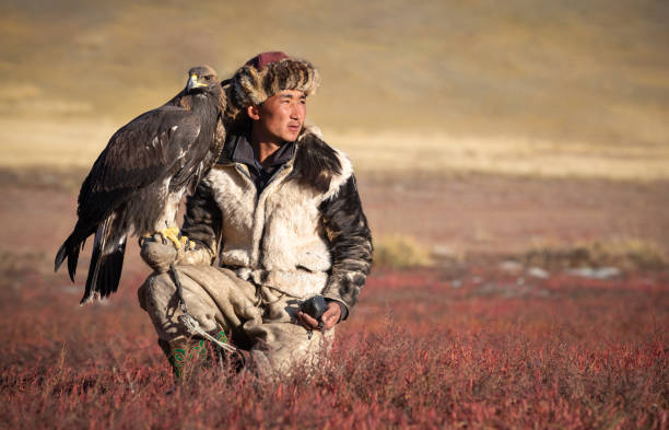 istock Young kazakh eagle hunter with his golden eagle. 1217313842