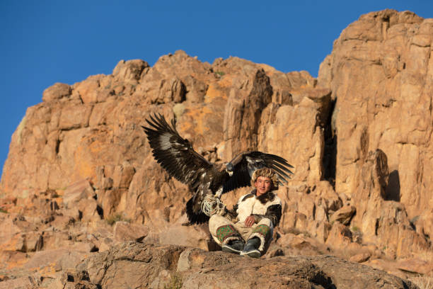 istock Young kazakh eagle hunter with his golden eagle. 1217313854