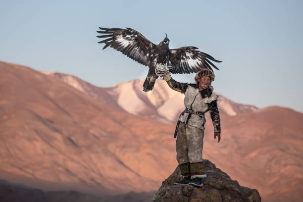 istock Young kazakh eagle hunter with his golden eagle. 1217313883