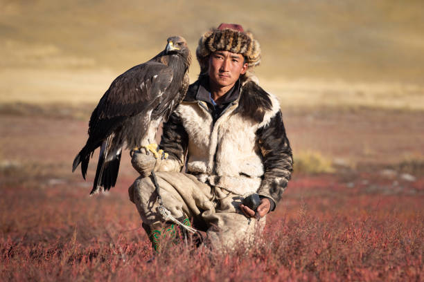 istock Young kazakh eagle hunter with his golden eagle. 1217314034