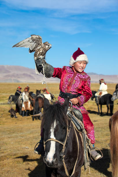 istock Young Mongolian boy with his falcon. 1217315181
