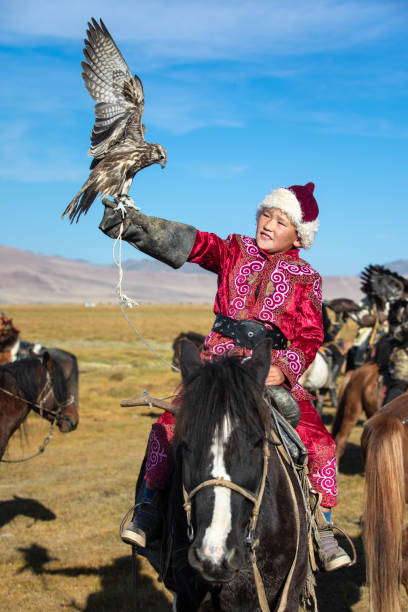 istock Young Mongolian boy with his falcon. 1217315212