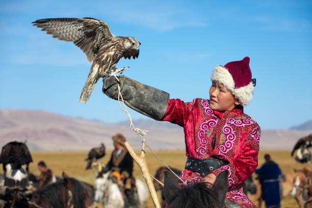 Young Mongolian boy with his falcon.