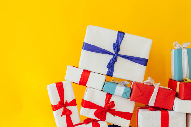 istock birthday or Christmas presents on a yellow background 1217316767