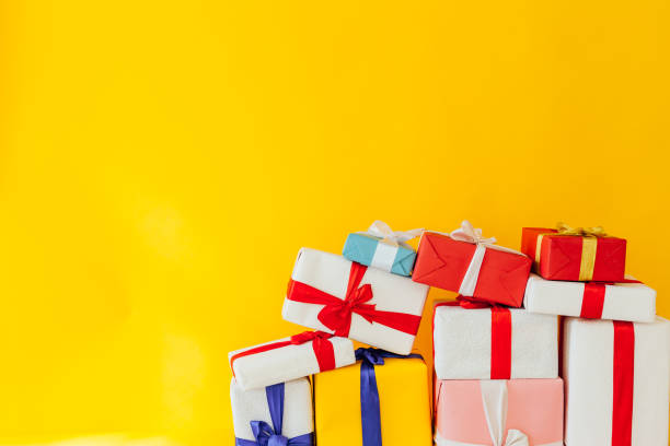 istock birthday or Christmas presents on a yellow background 1217316816