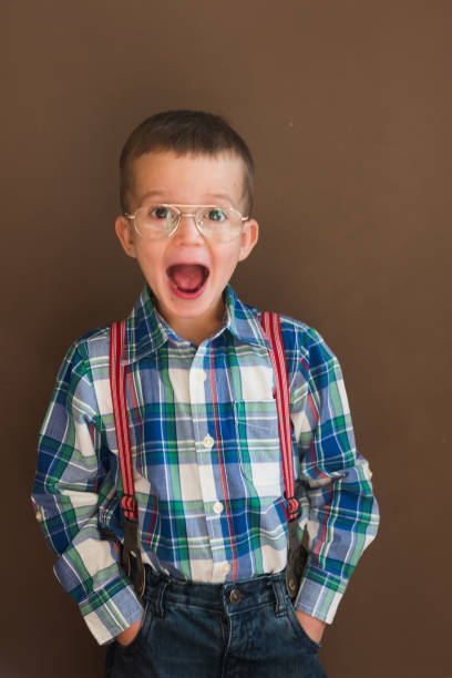 istock Smiling kid looking at camera in front of blackboard 1217320527