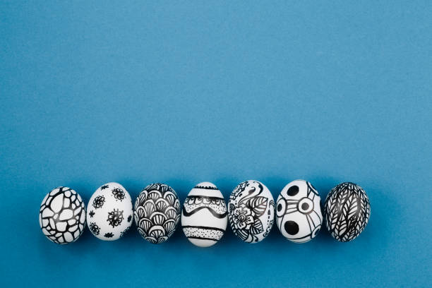 istock Easter eggs are painted black and white, abstraction, laid out in a row 1217321590