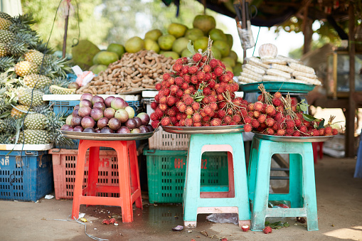 Various fruits, chlillies and vegetables offered at an Asian market in Cambodia