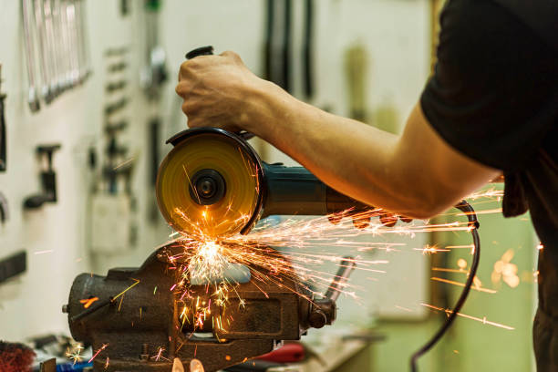 istock Close-up of a mechanic working as a grinder, sparks fly. 1217323091