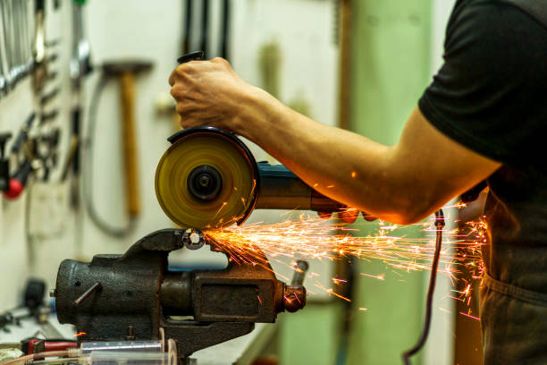 istock Close-up of a mechanic working as a grinder, sparks fly. 1217323106