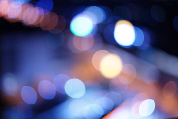 The orange, light blue, purple Blur bokeh, multicolored oval pattern dark background