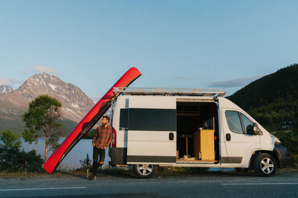 istock Man near the camper van with canoe on roof 1217323542
