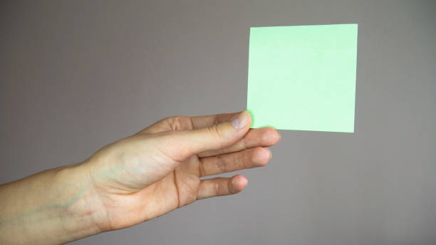 istock Square paper with space for text in the hand. 1217325178