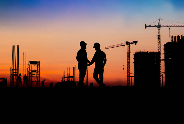 istock Silhouette Engineer and construction team working at site over blurred  industry background with Light fair Film Grain effect.Create from multiple reference images together 1217326325