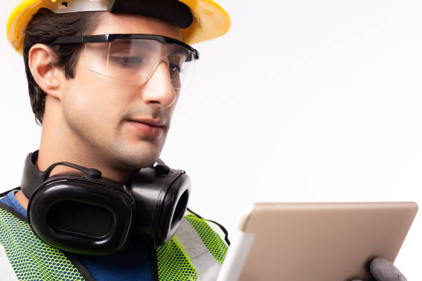istock Engineer man working on digital tablet computer at worksite or industry. Handsome young industrial worker planning and thinking job on tablet. Young men get successful of business. isolated on white 1217326354