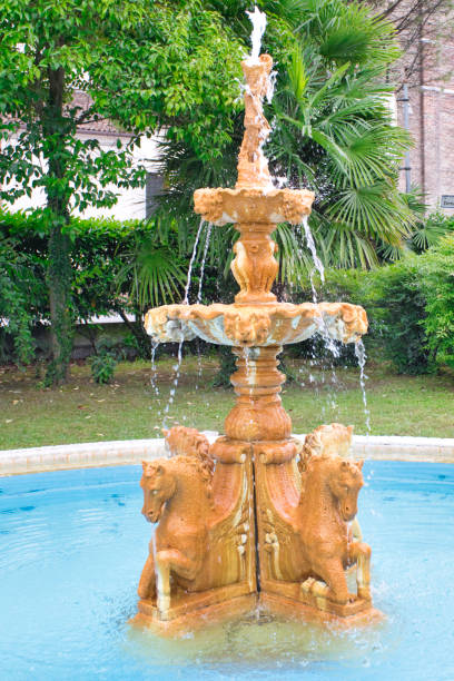 istock Golden colored monumental fountain with blue water fall down 1217326621